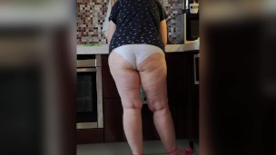 Mature housewife BBW MILF in the kitchen in white panties.