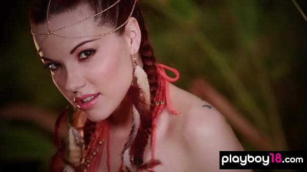 Inked teen Elizabeth Marxs showing her massive tits in a tropical forest